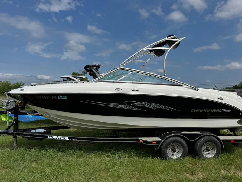 Slide: The Image of 2007 Chaparral 236 SSi boat on trailer, parked on grass under a blue sky. - 2
