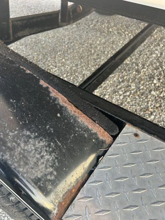 Slide: The Image of Close-up of a 2007 Chaparral 236 SSi boat trailer with rust and diamond plate detail. - 22