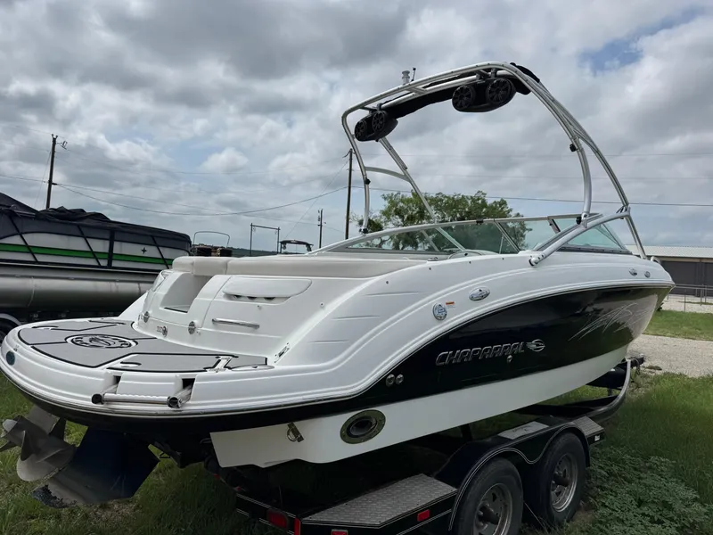 Slide: The Image of 2007 Chaparral 236 SSi boat on trailer, white and black design, cloudy sky background. - 5