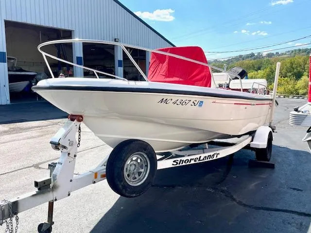 Slide: The Image of 2001 Boston Whaler 18 Dauntless boat on ShoreLand'r trailer, parked outdoors. - 4