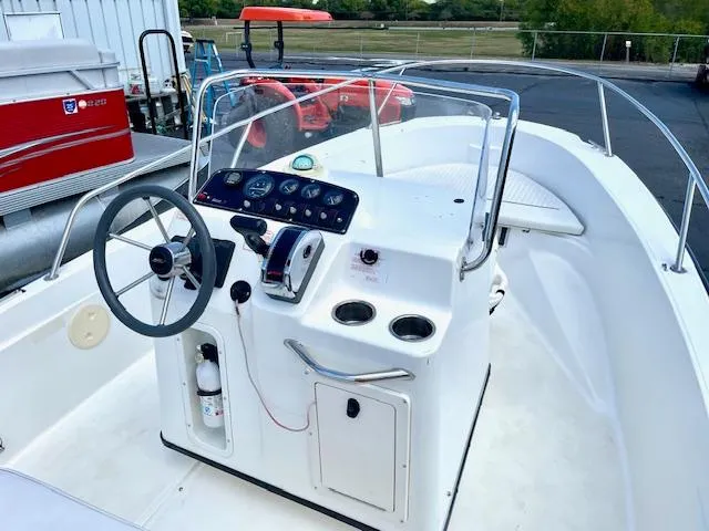 Slide: The Image of 2001 Boston Whaler 18 Dauntless boat cockpit with steering wheel and control panel. - 5