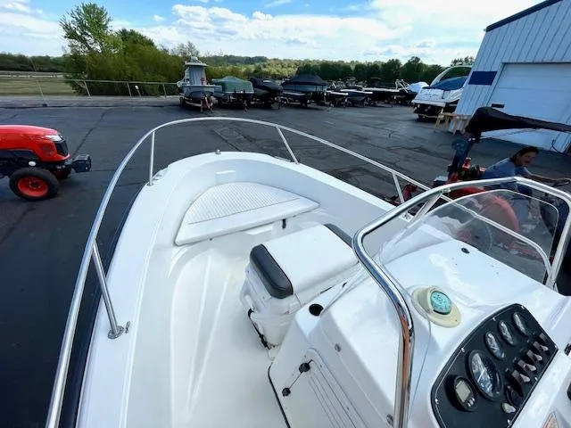 Slide: The Image of 2001 Boston Whaler 18 Dauntless boat docked, showcasing console and seating area. - 7