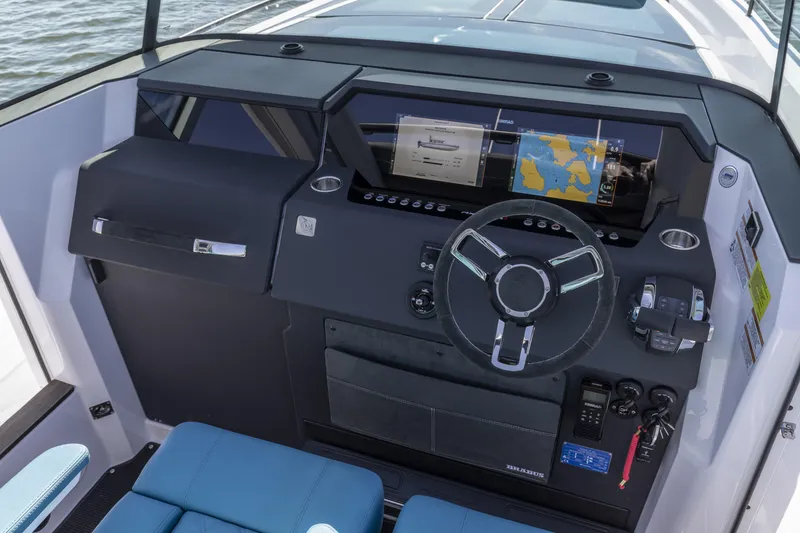 Slide: The Image of 2025 Axopar 37 XC CROSS CABIN dashboard with navigation display and steering wheel. - 21