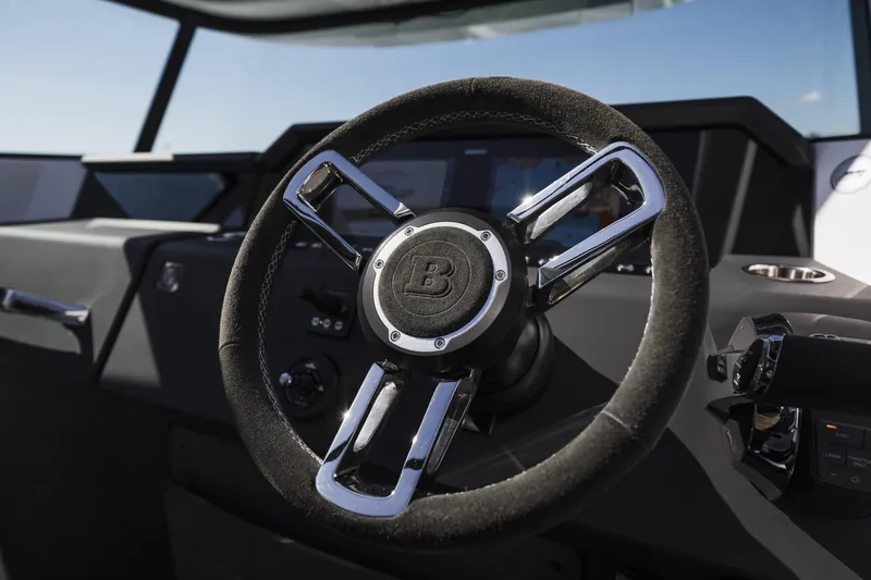 Slide: The Image of Steering wheel of 2025 Axopar 37 XC CROSS CABIN, showcasing modern design and controls. - 22