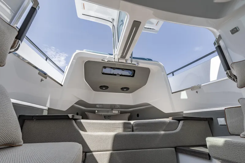 Slide: The Image of Interior view of 2025 Axopar 37 XC CROSS CABIN, showcasing modern seating and open roof design. - 30