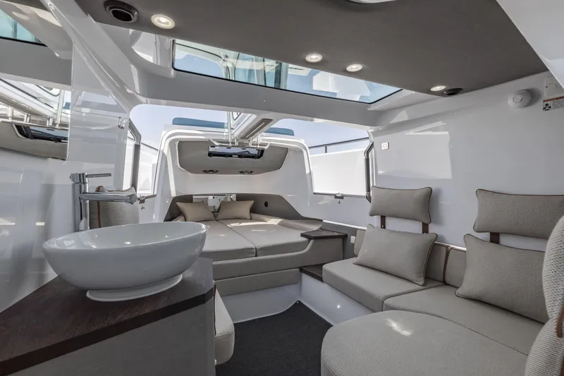Slide: The Image of Luxurious interior of 2025 Axopar 37 XC CROSS CABIN with modern seating and skylight. - 31