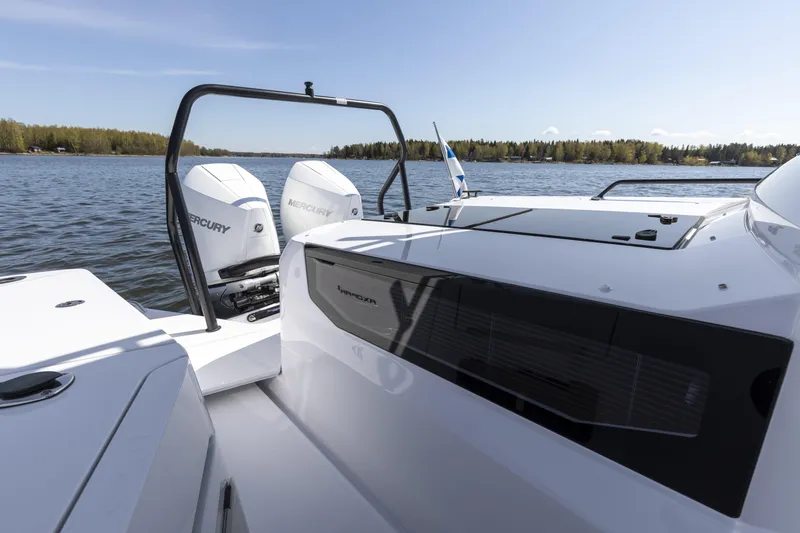 Slide: The Image of 2025 Axopar 37 XC CROSS CABIN with Mercury engines on a serene lake. - 40