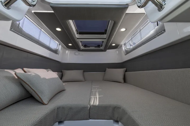 Slide: The Image of 2025 Axopar 37 XC CROSS CABIN interior with modern seating and skylights. - 43