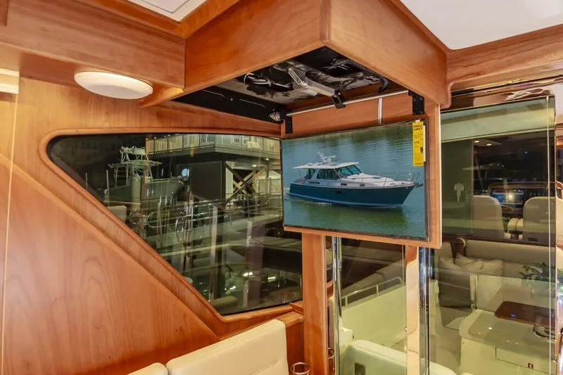 Slide: The Image of Interior of 2026 Sabre 43 Salon Express yacht with wooden finish and mounted screen. - 13