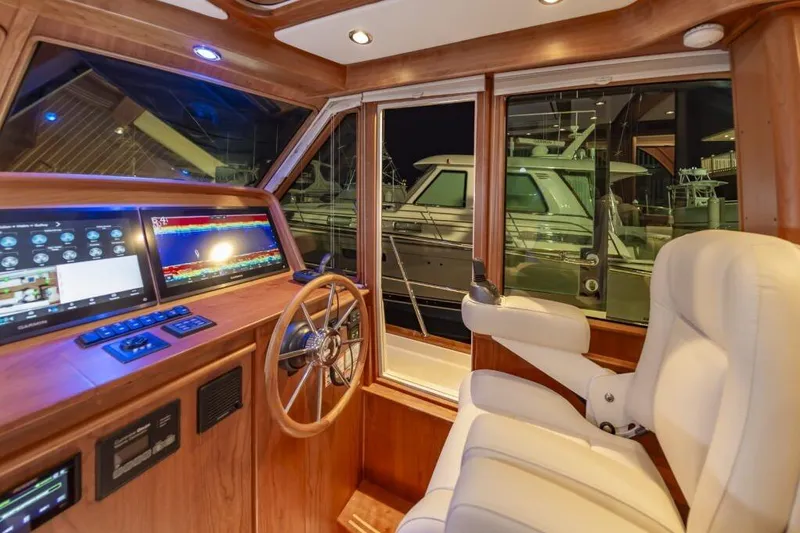Slide: The Image of Interior of 2026 Sabre 43 Salon Express with helm and monitors. - 36