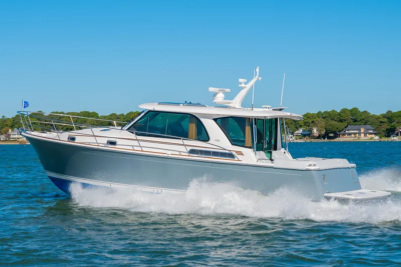 Slide: The Image of 2026 Sabre 43 Salon Express cruising on a sunny day, showcasing sleek design and performance. - 3