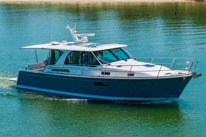 Slide: The Image of 2026 Sabre 43 Salon Express cruising on calm water. - 4