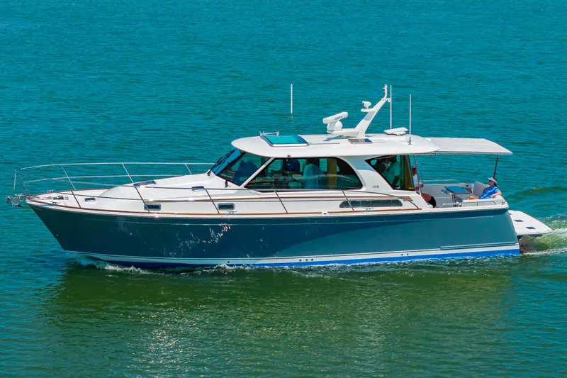 Slide: The Image of 2026 Sabre 43 Salon Express yacht cruising on clear blue water. - 6