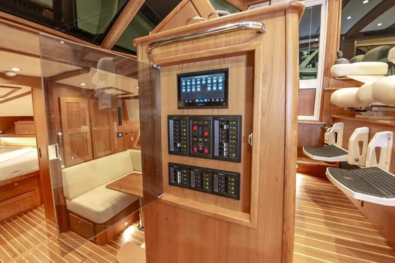 Slide: The Image of Interior of 2026 Sabre 43 Salon Express with wood paneling and control console. - 24