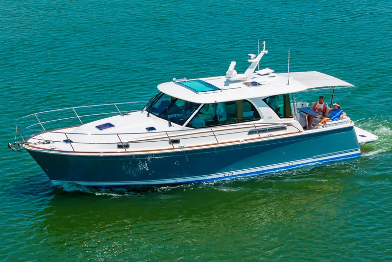 Slide: The Image of 2026 Sabre 43 Salon Express cruising on clear blue water. - 7