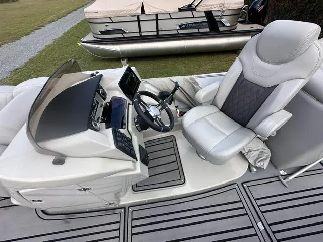 Slide: The Image of 2023 Starcraft SLS 3 boat cockpit with modern steering and comfortable seating. - 5