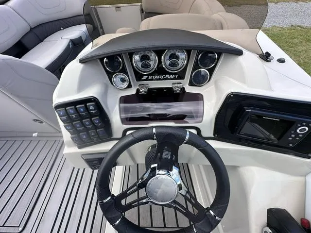 Slide: The Image of 2023 Starcraft SLS 3 boat dashboard with steering wheel and control panel. - 6