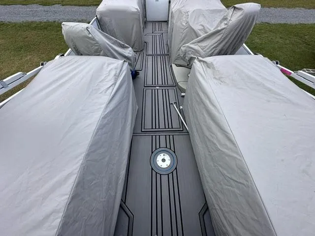 Slide: The Image of 2023 Starcraft SLS 3 boat interior with covered seats and sleek flooring. - 8