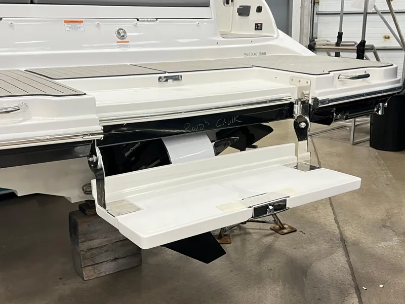 Slide: The Image of 2025 Sea Ray SDX 290 swim platform in a garage setting. - 4