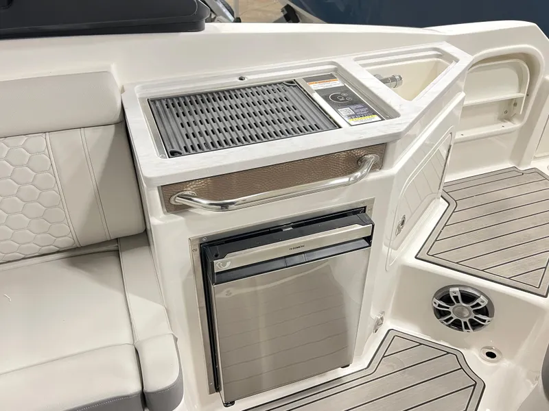 Slide: The Image of 2025 Sea Ray SDX 290 boat interior with grill and mini fridge. - 7