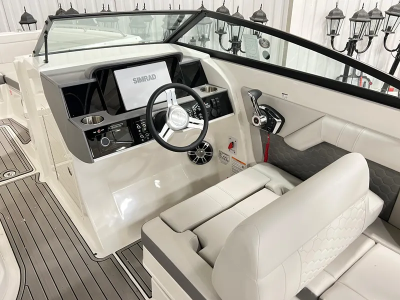 Slide: The Image of 2025 Sea Ray SDX 290 boat cockpit with modern steering and navigation system. - 9