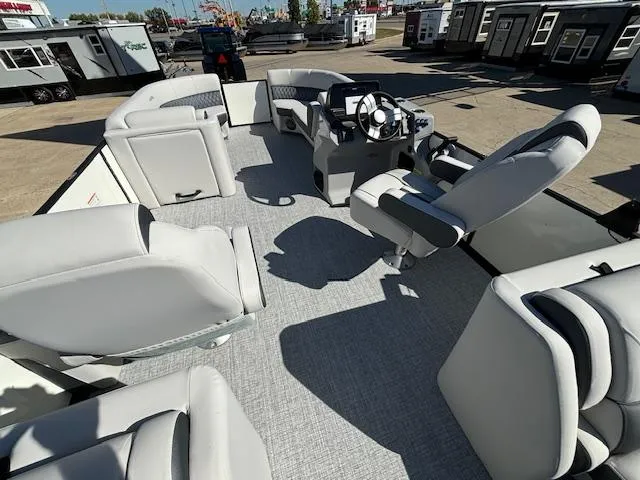 Slide: The Image of 2024 Harris Sunliner 230 CWDH pontoon boat interior with plush seating and modern helm. - 11