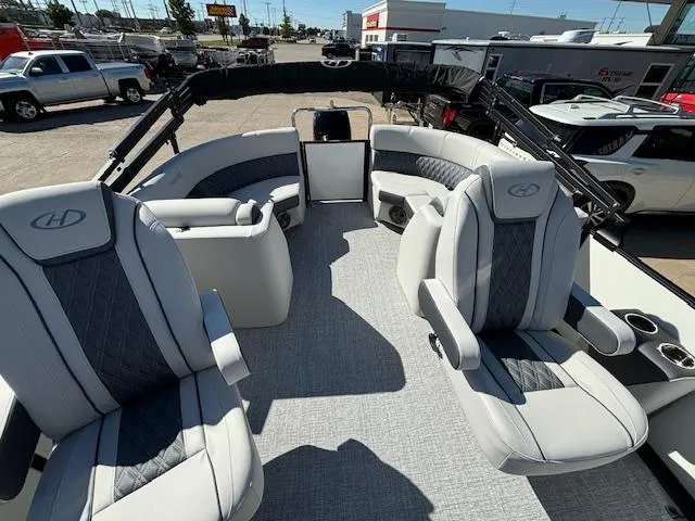 Slide: The Image of 2024 Harris Sunliner 230 CWDH pontoon boat interior with plush seating and modern design. - 15