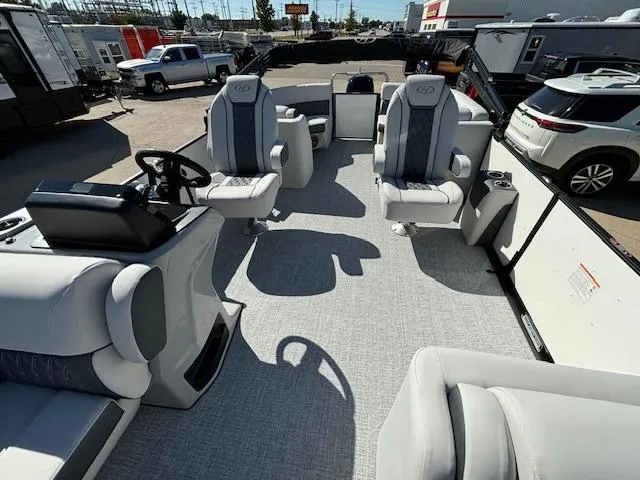 Slide: The Image of 2024 Harris Sunliner 230 CWDH pontoon boat interior with plush seating and modern helm. - 17