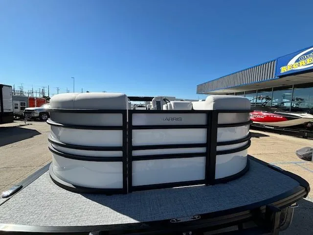 Slide: The Image of 2024 Harris Sunliner 230 CWDH pontoon boat at dealership, sunny day. - 2