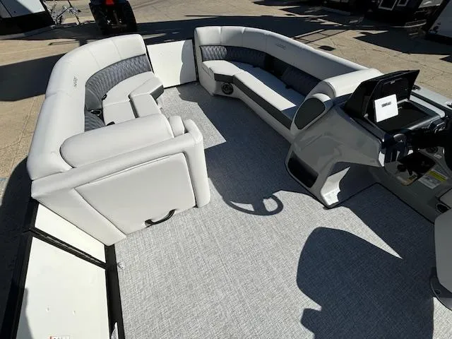 Slide: The Image of 2024 Harris Sunliner 230 CWDH boat interior with spacious seating and modern helm. - 3
