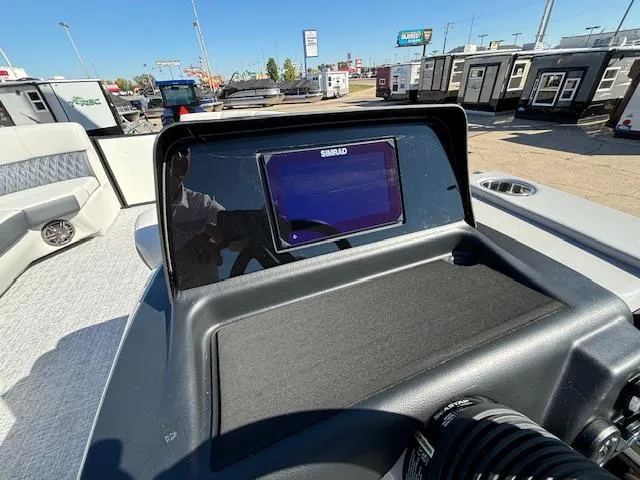 Slide: The Image of 2024 Harris Sunliner 230 CWDH dashboard with Simrad display in a boat showroom. - 5
