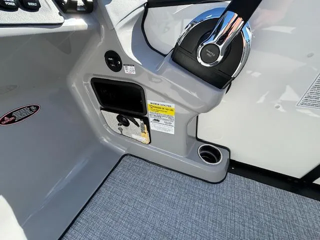 Slide: The Image of 2024 Harris Sunliner 230 CWDH boat interior with steering wheel and control panel. - 6