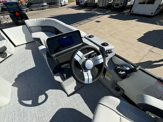 Slide: The Image of 2024 Harris Sunliner 230 CWDH boat interior with steering wheel and control panel. - 7