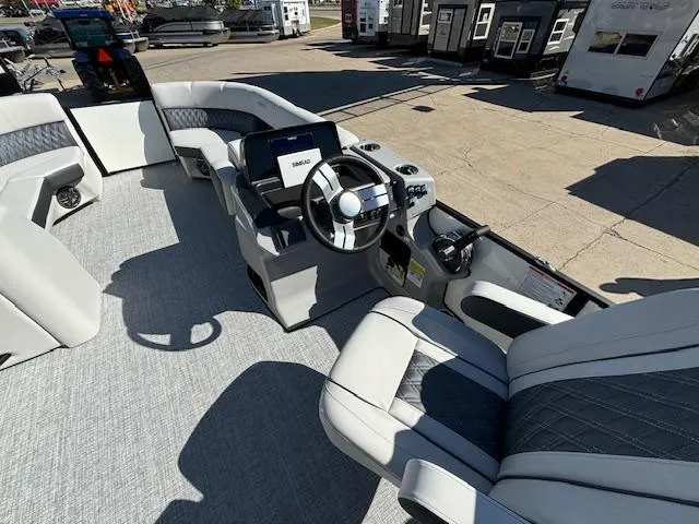 Slide: The Image of 2024 Harris Sunliner 230 CWDH boat interior with modern steering and seating. - 8