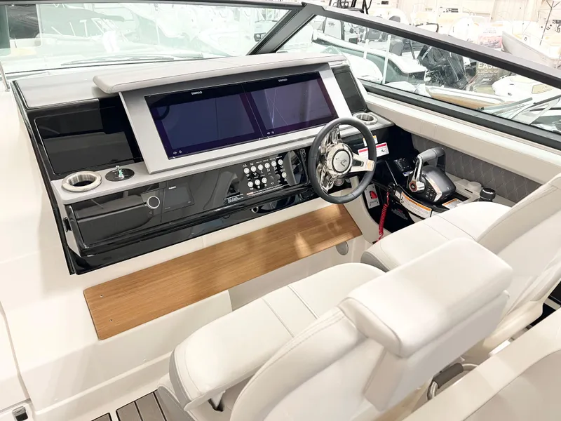 Slide: The Image of 2025 Sea Ray SLX 400 helm with modern controls and dual screens. - 10