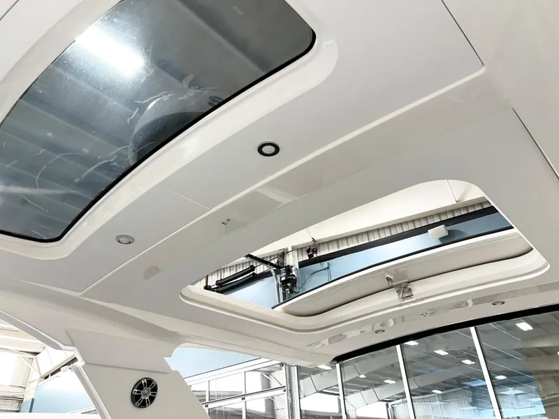 Slide: The Image of 2025 Sea Ray SLX 400 boat interior with sunroof and modern design. - 11