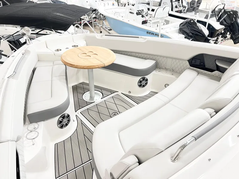 Slide: The Image of 2025 Sea Ray SLX 400 boat interior with elegant seating and wooden table. - 13
