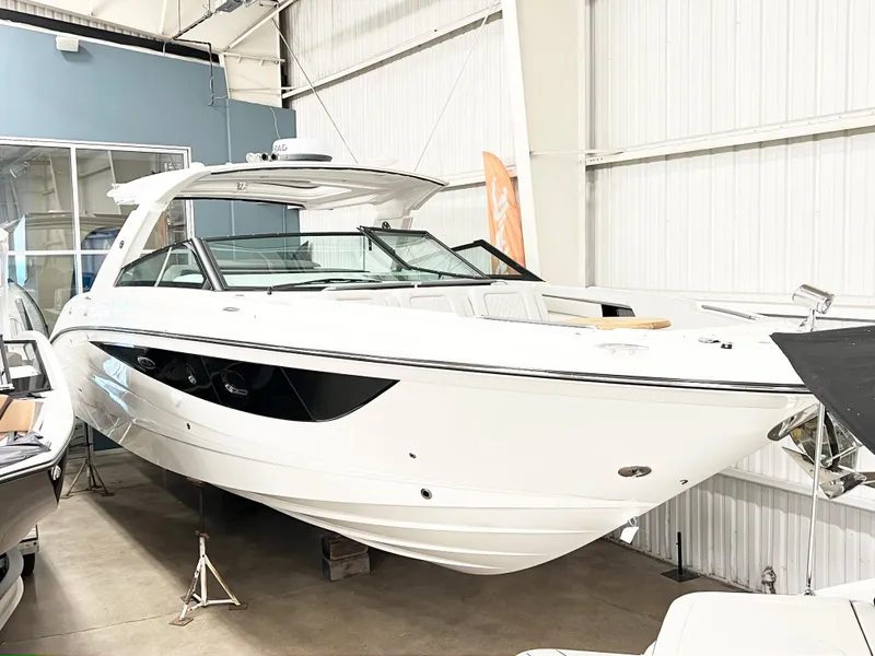 Slide: The Image of 2025 Sea Ray SLX 400 luxury boat displayed in a showroom. - 17