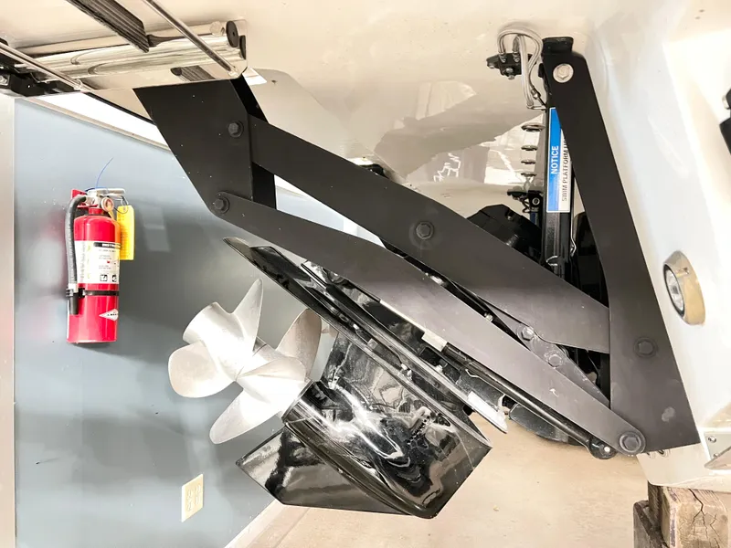 Slide: The Image of Sea Ray SLX 400 2025 boat propeller and fire extinguisher in storage area. - 5