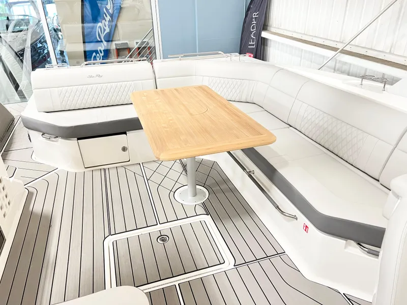 Slide: The Image of 2025 Sea Ray SLX 400 boat interior with elegant seating and wooden table. - 7