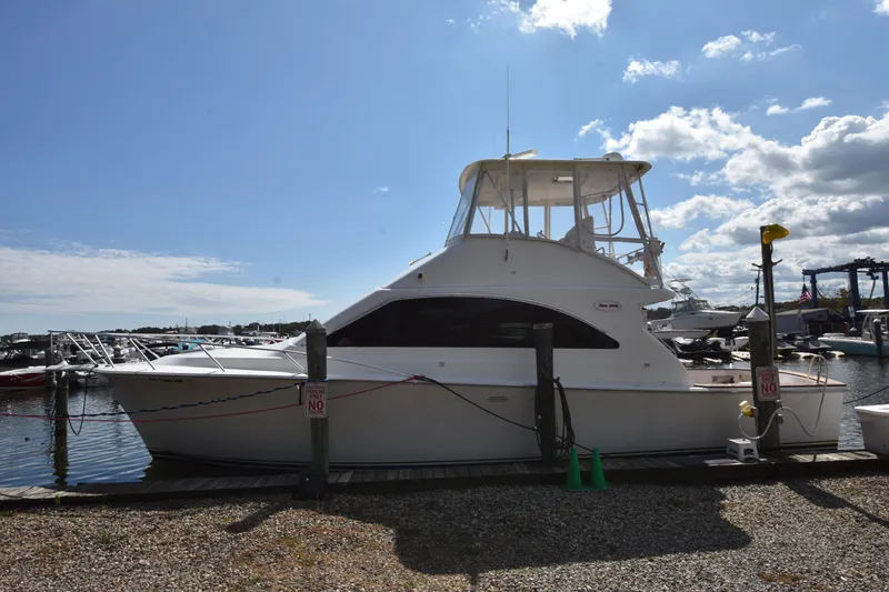 Slide: The Image of 2003 Ocean Yachts 40 Super Sport docked at marina under blue sky. - 3