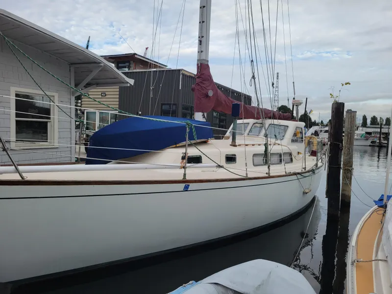 Slide: The Image of 1967 Spencer 42 sailboat docked at a marina, featuring classic design and white hull. - 1