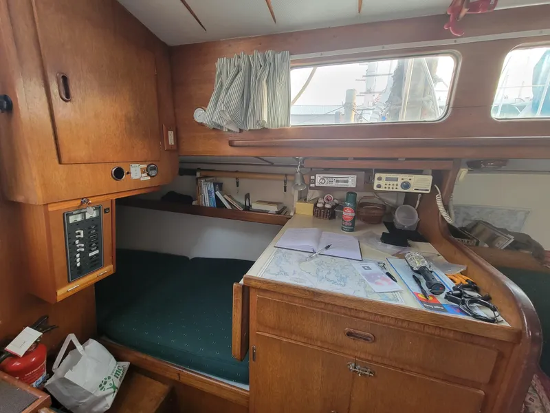 Slide: The Image of 1967 Spencer 42 sailboat cabin with navigation desk and cozy sleeping area. - 20