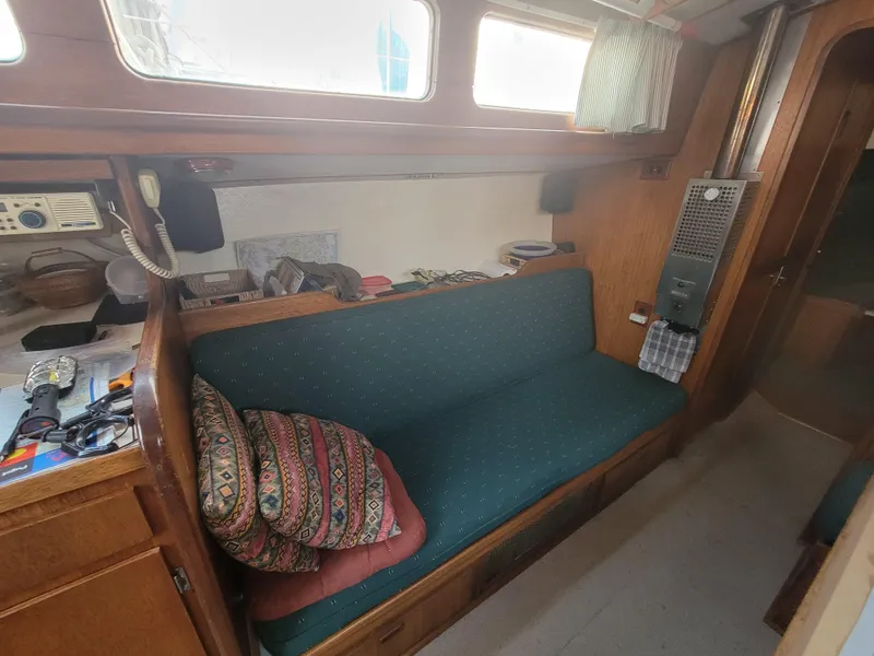 Slide: The Image of 1967 Spencer 42 sailboat interior with teal seating and colorful cushions. - 24