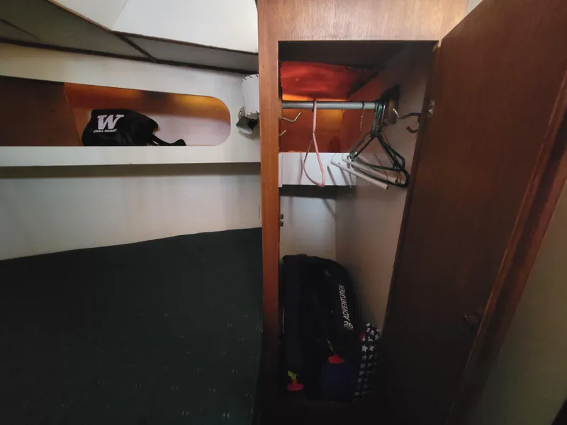 Slide: The Image of Small cabin interior with closet, hangers, and luggage on a Spencer 42 sailboat, 1967 model. - 27