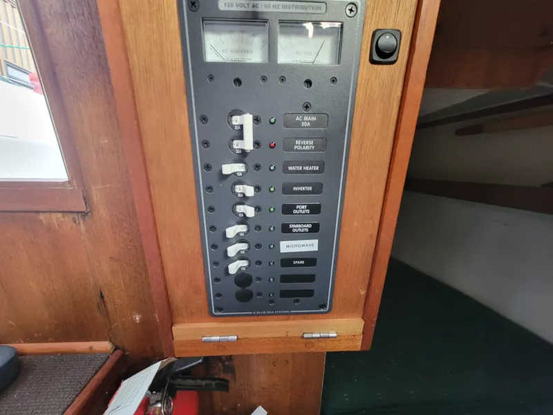 Slide: The Image of Electrical panel on a 1967 Spencer 42 boat, featuring switches and meters. - 29