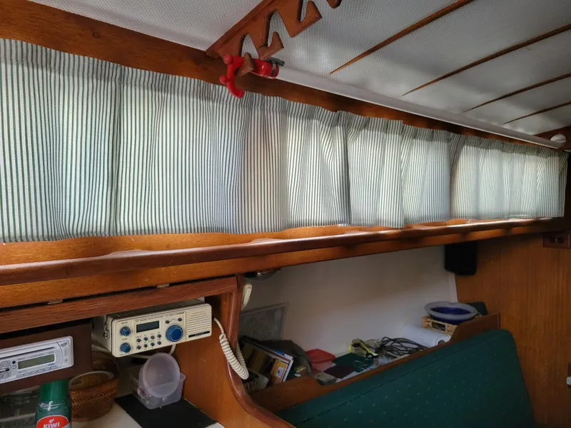 Slide: The Image of Interior of a 1967 Spencer 42 sailboat with striped curtains and vintage radio equipment. - 36
