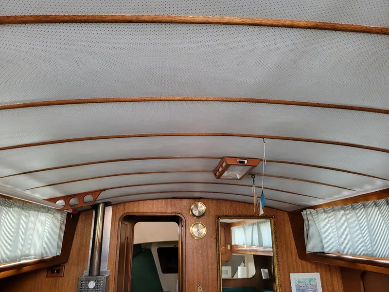Slide: The Image of Interior of a 1967 Spencer 42 boat with wood paneling and nautical decor. - 38