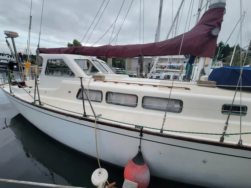 Slide: The Image of 1967 Spencer 42 sailboat docked at marina, overcast sky. - 4