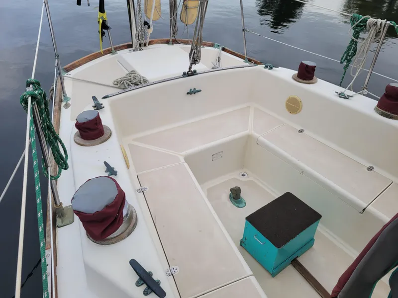 Slide: The Image of 1967 Spencer 42 sailboat cockpit with winches and ropes, docked on calm water. - 40
